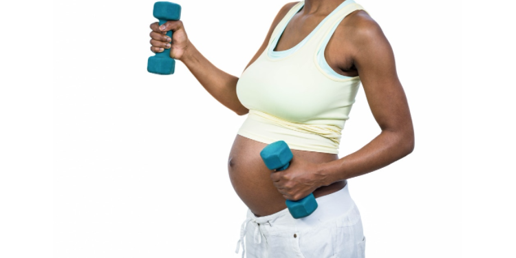 black pregnant woman exercising with weights