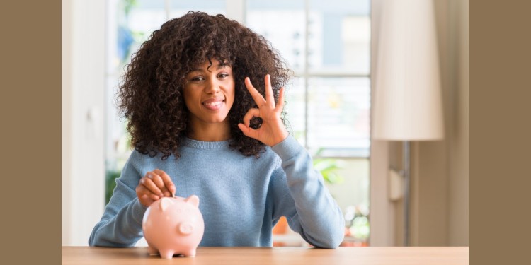 young woman saving money in piggy bank