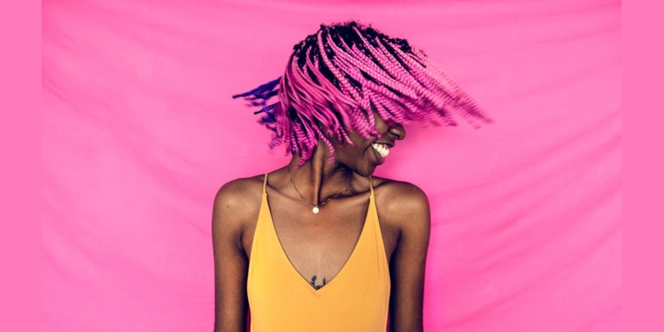 Young black woman rocking her colored hair