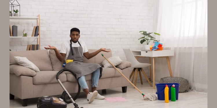 Young man feeling reluctant to do house chores