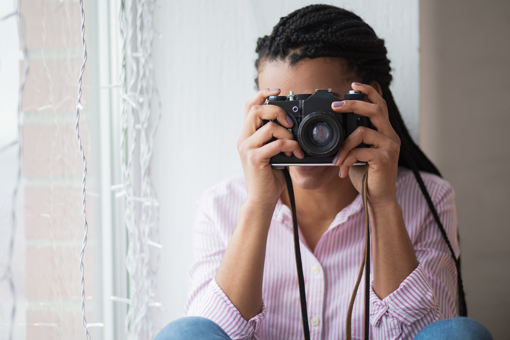 Female photographer creating content at home