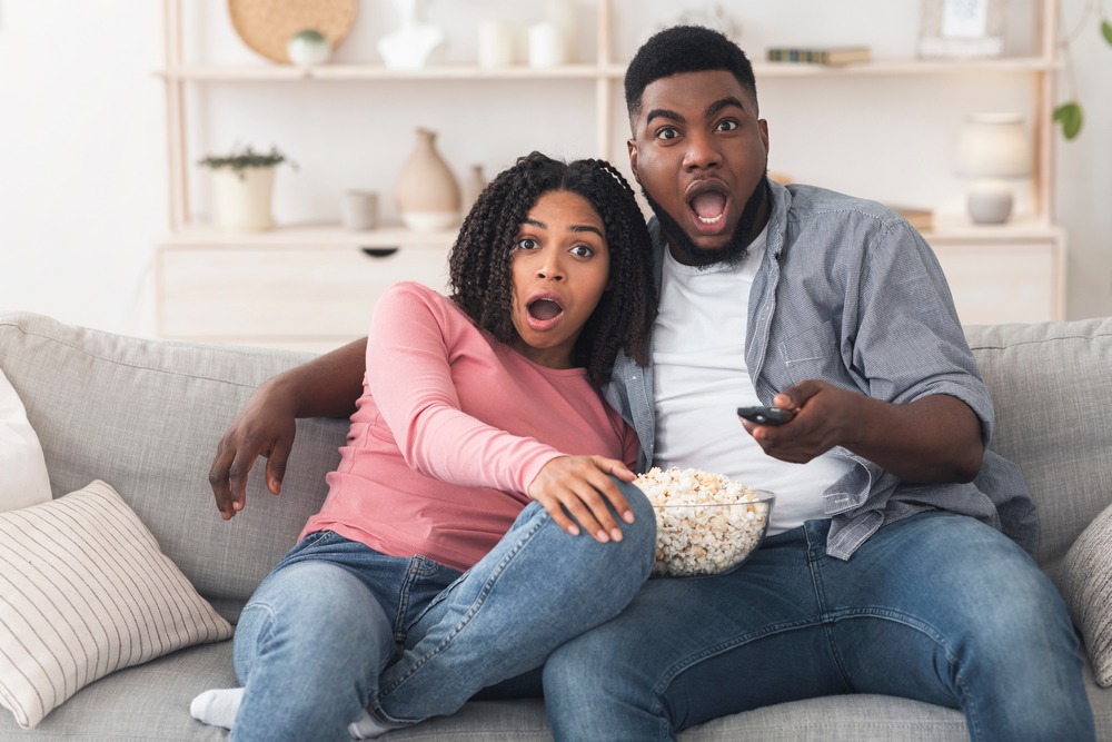 Young couple surprised by a TV show