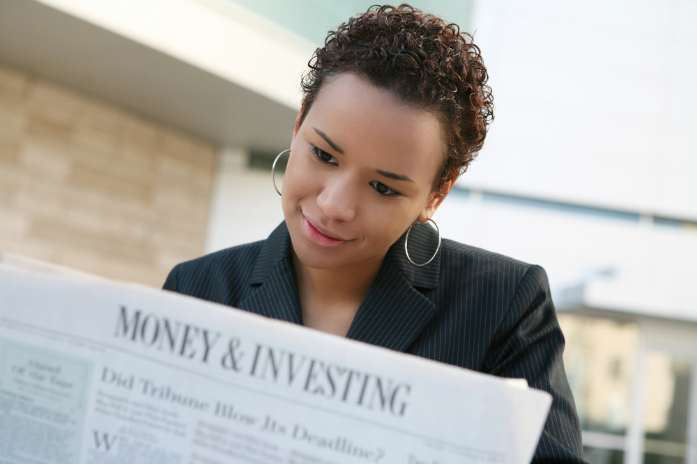 Young woman researching on investing