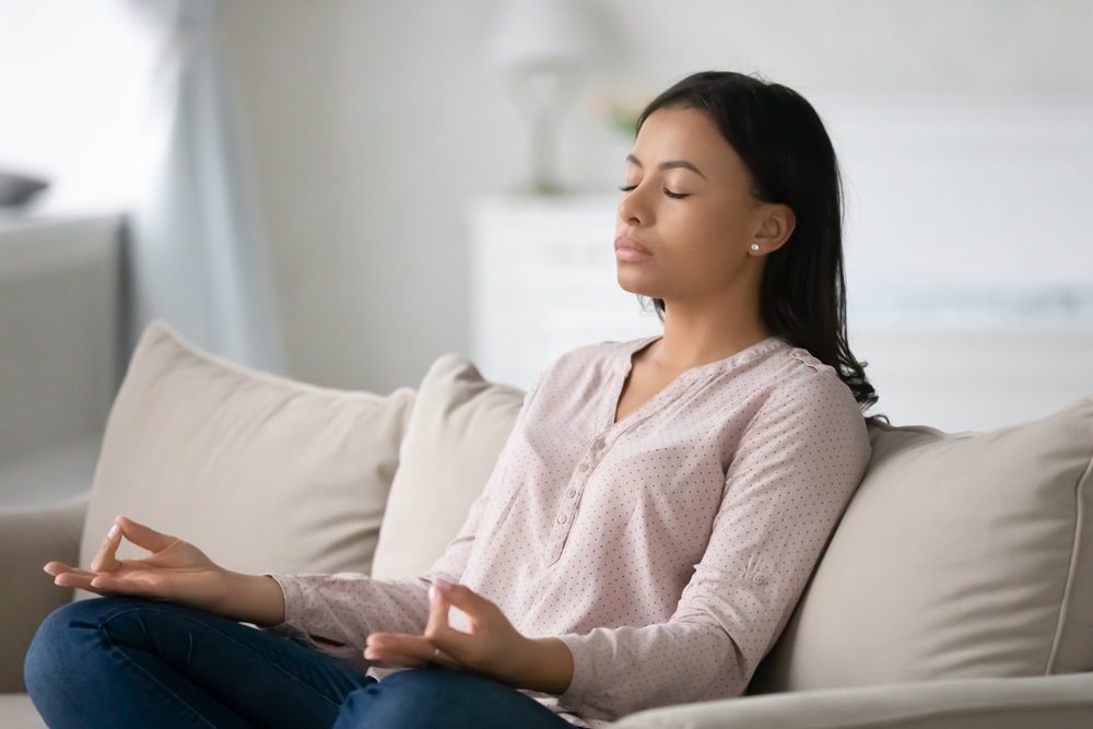 Young woman meditating on her emotional health.