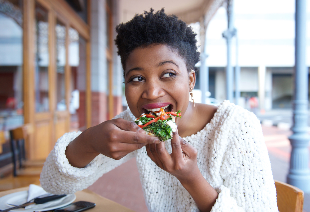 young African american woman enjoying a snack.