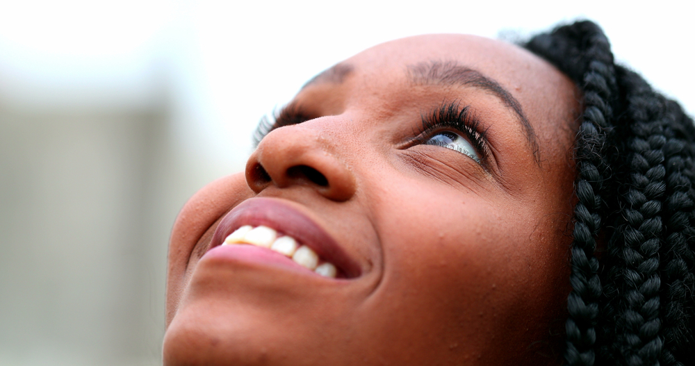 Woman looking up and optimistic about the future